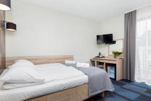 Postel nebo postele na pokoji v ubytování Nawigator SPA