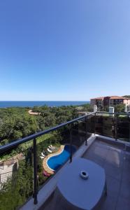 a balcony with a view of a swimming pool at Vesta Riviera - Free Parking in Golden Sands
