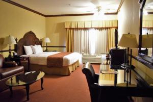 a hotel room with a bed and a couch at Folk Inn Ontario Airport in Ontario
