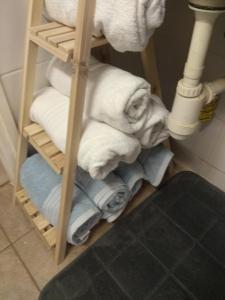 a pile of towels on a shelf in a bathroom at צימר בודד בגליל העליון in Kefar Szold