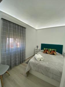 a bedroom with a bed and a large window at Casa da Matriz in Vidigueira