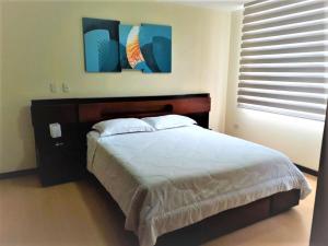 Postel nebo postele na pokoji v ubytování Misuitehotel La Carolina Quito