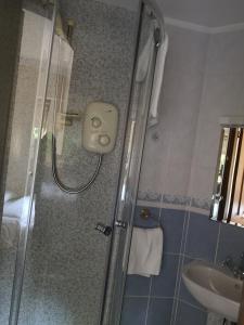 a bathroom with a shower and a sink at Granville Guest House in Dyce