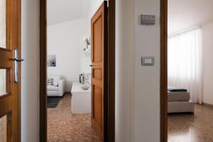 a hallway with a door open to a bathroom at Fly by Suites Pescara in Pescara