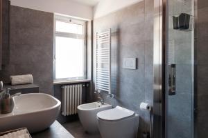a bathroom with a tub and a sink and a toilet at Fly by Suites Pescara in Pescara