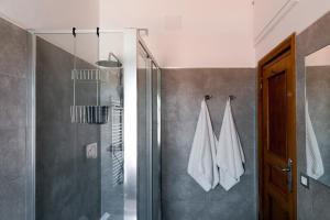 a bathroom with a shower and a glass shower stall at Fly by Suites Pescara in Pescara