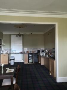 a large kitchen with a table and a counter top at Granville Guest House in Dyce