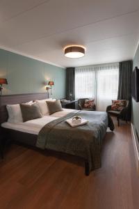 a bedroom with a large bed and a living room at Blix Hotel in Vikøyri