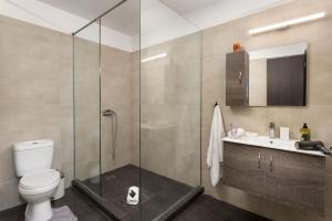 a bathroom with a shower and a toilet and a sink at The Aristotelian Suites by Athens Stay in Athens