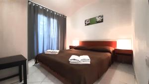 a bedroom with a bed with towels on it at Apartments Nadia Sokolić in Nerezine