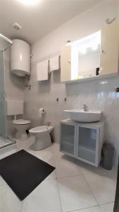 a bathroom with a sink and a toilet at Apartments Nadia Sokolić in Nerezine