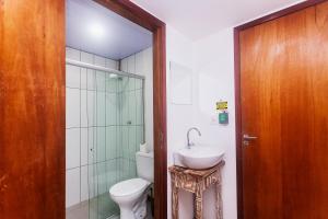 a bathroom with a toilet and a sink and a shower at Economy Suites in Natal +28 photos