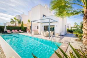 a swimming pool in front of a villa at Villa de lujo Rojales in Rojales