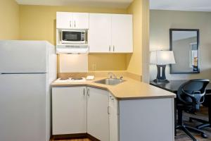a kitchen with a white refrigerator and a sink at Extended Stay America Suites - Washington, DC - Springfield in Springfield