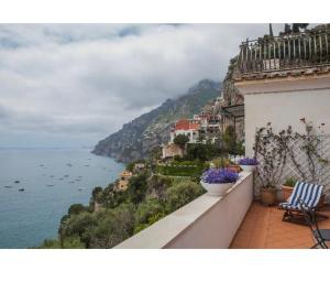 a balcony with two chairs and a view of the ocean at Casa Marty in Positano