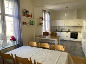 a kitchen with a table and chairs and a dining room at Vänersborgs Vandrarhem in Vänersborg