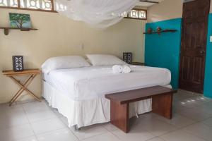 a bedroom with a bed and a dresser at Casa Marimba in La Laguna