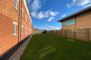 a large yard next to a brick building at Appleby Darlington Two in Darlington