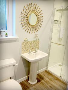 a bathroom with a sink and a shower at The Auld Reekie in Barbaraville