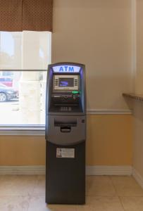 an atm machine in a room with a window at Days Inn by Wyndham Shenandoah in The Woodlands