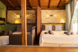 a bedroom with two beds and a couch in it at Wood Aesthetic Steps from the Sea in Thessaloniki