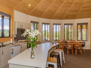 a kitchen and dining room with a table and chairs at The Snowglobe - Ohakune Modern Yurt Style Chalet in Ohakune