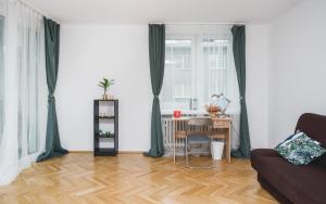 a living room with a table and a couch at Sunshine Parkside Hideaway - 3 Bedroom in Kraków