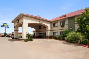 a hotel with a parking lot in front of it at Days Inn by Wyndham Childress in Childress