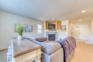 a living room with a couch and a fireplace at Pine Beach House in Rockaway Beach
