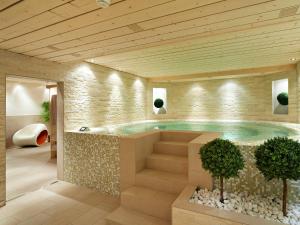 un gran cuarto de baño con jacuzzi en un edificio en Hôtel Vanessa, en Verbier
