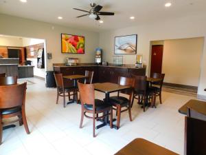 a dining room with tables and chairs in a restaurant at Island Suites in Lake Havasu City
