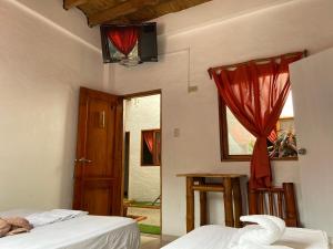 Postel nebo postele na pokoji v ubytování Hotel Karukera