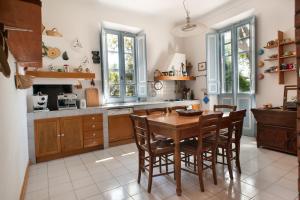 a kitchen with a wooden table and chairs at Villa CORALIA D'EPOCA in Osimo