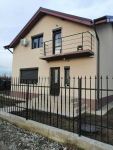 a house with a fence in front of it at Casa Mirela in Bucharest
