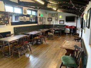 a room with tables and chairs in a restaurant at The Lion Brewery in Ash