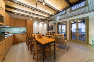 a kitchen and dining room with a wooden table and chairs at Villa Ambrosia, beach house, Platanidia, Pelion in Platanidia