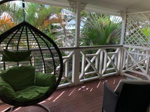 a porch with a chair and a swing at Waterfront Lodge in Nuku‘alofa