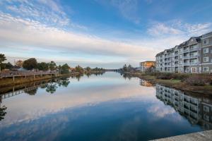 une rivière avec des bâtiments sur son côté dans l'établissement Rivertide Suites, à Seaside