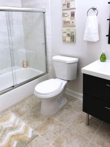 a bathroom with a toilet and a shower and a sink at Downtown Oasis - Location - Comfort - Style in Atlanta