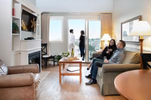 a group of people sitting in a living room at Rivertide Suites in Seaside