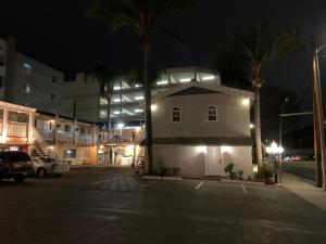 a white building with lights on a street at night at 777 Motor Inn in Sherman Oaks