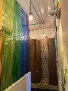 a bathroom with a colorful wall of glass at The Corner House Hostel in Salento