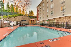 a swimming pool with a no swimming sign next to a building at Holiday Inn Express Hotel & Suites Columbus-Fort Benning, an IHG Hotel in Columbus