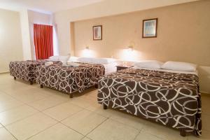 En eller flere senger på et rom på Hotel Colon Merida
