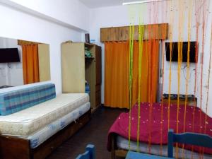 a room with two beds in a room with colorful curtains at Ayre del Tuyu in Mar del Tuyú +3 photos