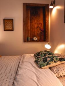 a bed in a bedroom with a picture on the wall at La Belle Landaise 1809 studio 4 couchages in Peyrehorade