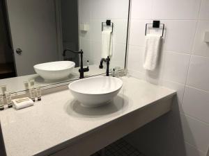 a bathroom with two sinks and a mirror at Greenmount Beach House in Gold Coast