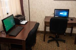 a desk with a laptop computer on it at Holiday Lodge Hotel and Conference Center in Oak Hill