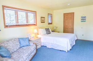 a bedroom with a bed and a couch at Sea Treasures Inn in Seward