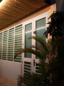 a front door of a house with windows at Cozy Beach Apartment in San Juan